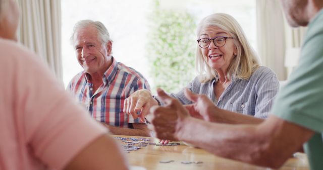 Happy Elderly Friends Enjoying a Puzzle Game Together - Download Free Stock Images Pikwizard.com