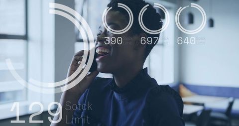 Laughing woman using smartphone in modern coworking lounge with digital HUD overlays