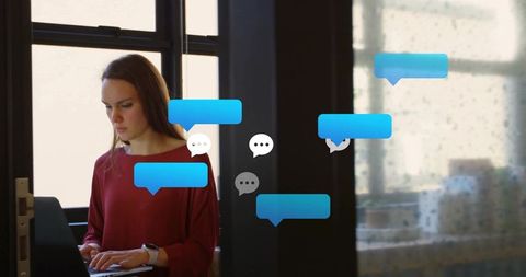 Modern communication: professional woman typing at desk in bright workspace