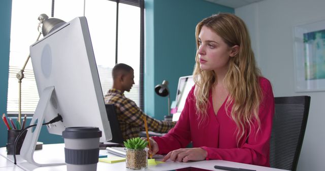 Focused Businesswoman Working on Desktop Computer in Modern Office - Download Free Stock Images Pikwizard.com