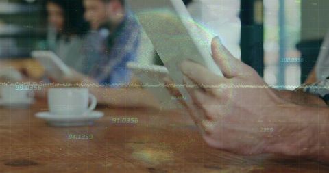 Businessman using tablet at modern coffee shop