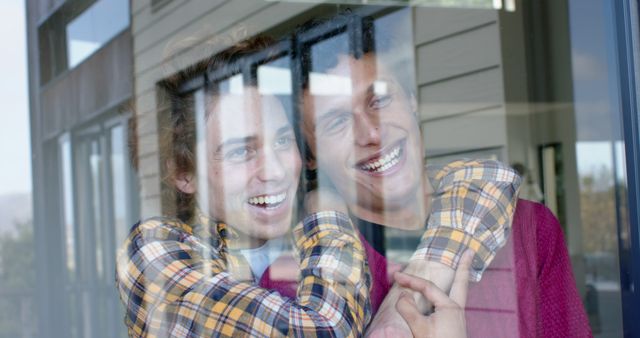 Young Friends Smiling and Hugging Through Glass Window Reflection - Download Free Stock Images Pikwizard.com