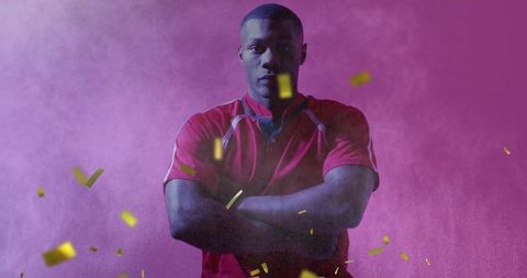 Confetti Falling over Confident African American Athlete in Colorful Spotlight