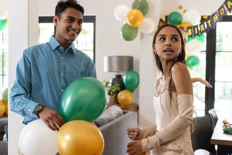 Couple celebrating birthday with balloon decorations