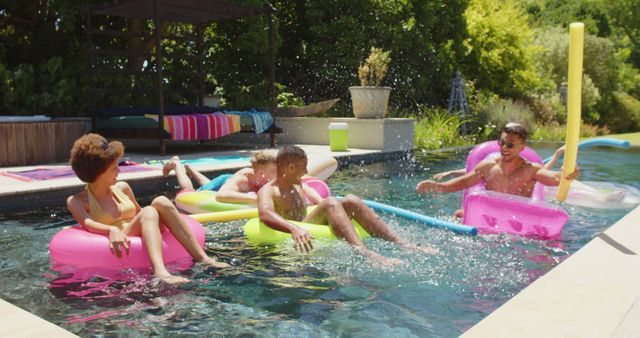 Group of friends in outdoor pool relaxing on inflatable floats, enjoying summer sun, having fun splashing water. Perfect for promoting summer vacations, pool parties, leisure activities, and outdoor lifestyle.