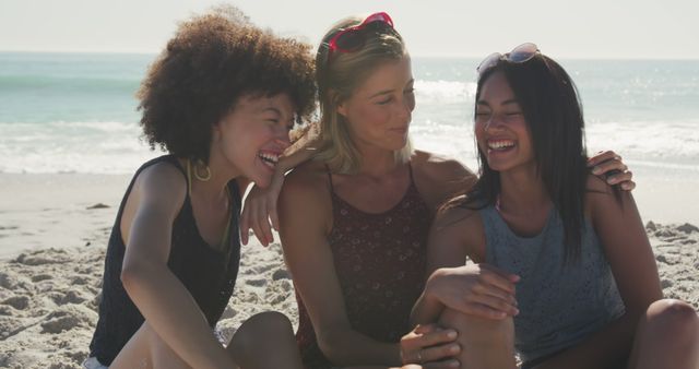 Diverse women sitting and laughing on beach. Summer, free time, chill, vacation, happy time, friendship.
