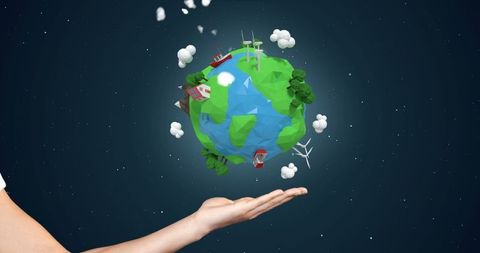 Hand holding miniature earth with wind turbines