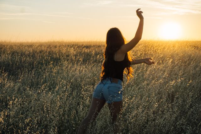 Woman Dancing in Field at Sunset - Download Free Stock Photos Pikwizard.com