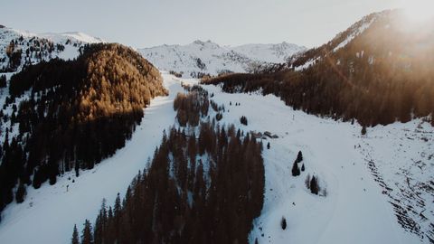 Winter Sunrise Over Snowy Mountain Ski Slopes