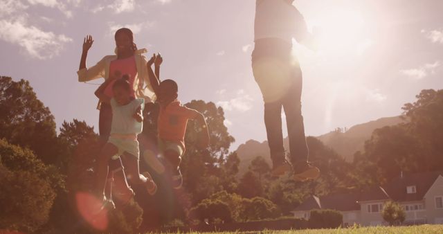 Family enjoying time together in a park during sunset. Great for advertisements related to family life, outdoor activities, and healthy lifestyle. Perfect for use in campaigns promoting family bonding and recreation.