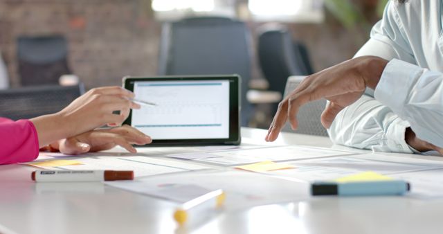 Business Colleagues Analyzing Financial Data on Tablet in Office Meeting - Download Free Stock Images Pikwizard.com