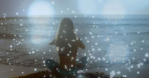 Woman Practicing Yoga at the Beach with Digital Light Effect
