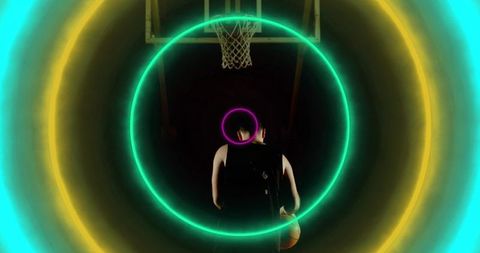 Dynamic basketball player with vibrant neon rings in arena