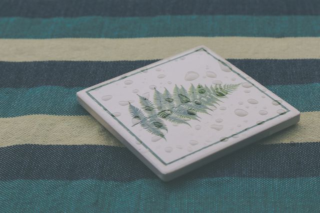 Droplets on Fern Print Tile on Striped Fabric Background - Download Free Stock Photos Pikwizard.com