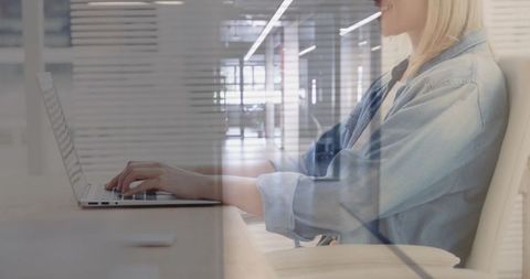 Businesswoman Using Laptop in Modern Office Space