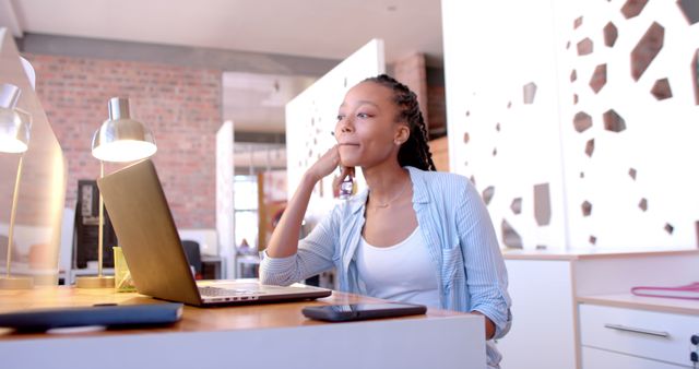 Young Woman Working at Desk with Laptop in Modern Office - Download Free Stock Images Pikwizard.com