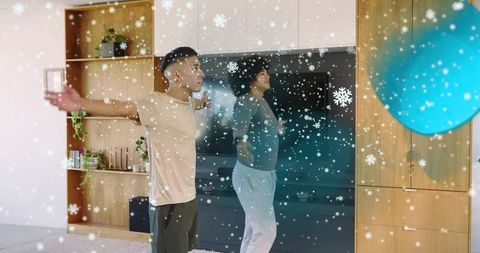 Young men stretching in minimalist living room with snowflake overlay and blue exercise ball