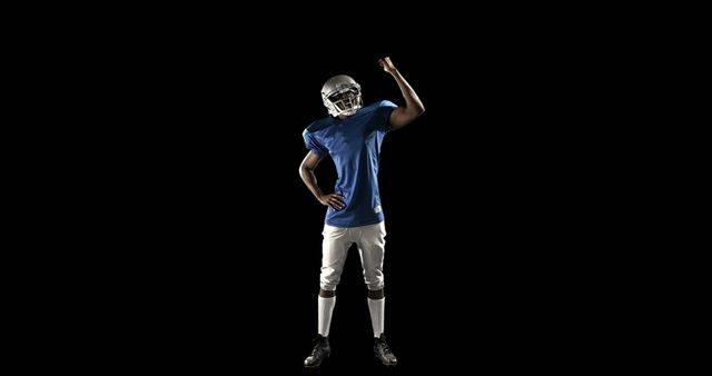 American Football Player Raising Fist in Victory on Black Background - Download Free Stock Images Pikwizard.com