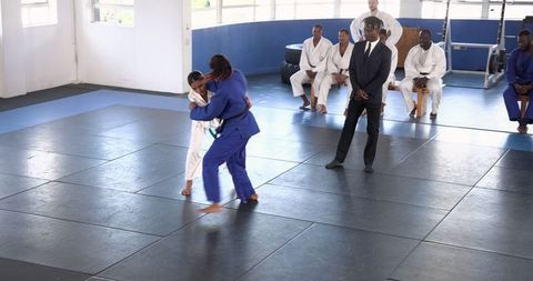 Teenage Girls Engaging in Judo Discipline in Gym Arena