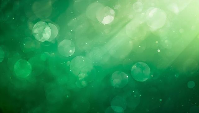 Emerald Glow Bokeh Backdrop with Soft Light Rays, Translucent Orbs and Subtle Particles