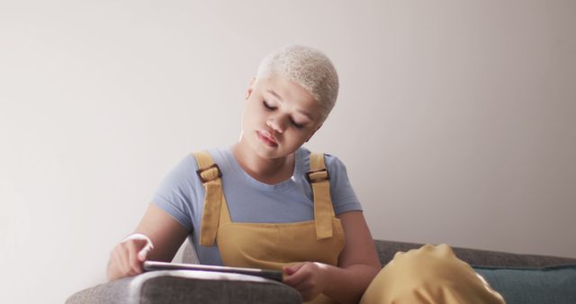 Woman Relaxing on Sofa Using Tablet, Casual Outfit - Download Free Stock Images Pikwizard.com