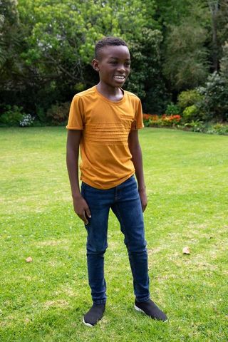 Smiling African American Boy on Lush Green Lawn