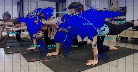 Group pilates class balancing bird-dog core exercise with global fitness data overlay