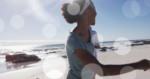 Joyful African American Couple Enjoying Beachfront in Sunlight