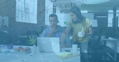 Coworkers Analyzing Financial Charts with Teamwork in Modern Office