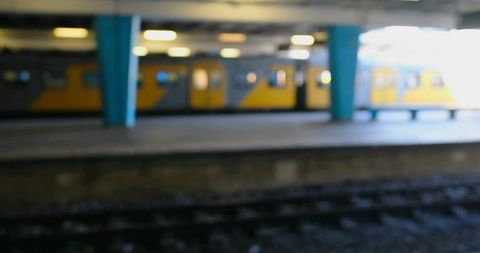 Unfocused subway train in bustling station