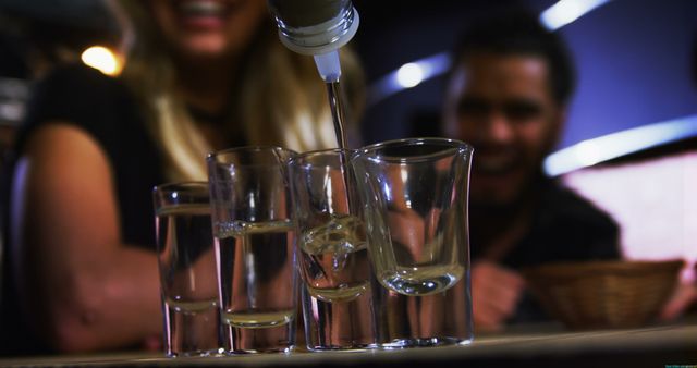 Pouring Shots in Bar with Smiling Friends - Download Free Stock Images Pikwizard.com