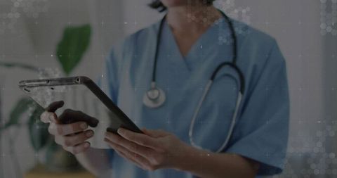 Healthcare Professional Utilizing Tablet Technology in Medical Clinic