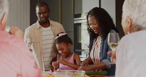 Multigenerational Mixed-Race Family Preparing Meal Together in Modern Kitchen Island
