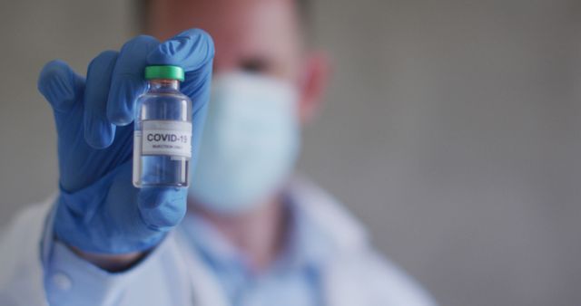 Healthcare Professional Holding COVID-19 Vaccine Bottle - Download Free Stock Photos Pikwizard.com