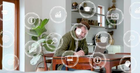 Man Writing at Home Office Table Using Laptop and Headphones with Digital Productivity HUD