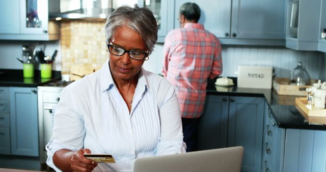 Senior Woman Shopping Online in Modern Kitchen with Laptop - Download Free Stock Images Pikwizard.com