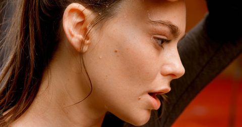 Focused athletic woman sweating after workout