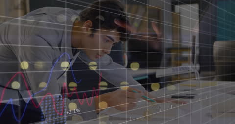 A concentrated young professional is working intensely on financial data, symbolized by superimposed graphs and charts. This visual highlights themes of financial analytics and strategic business thinking. Ideal for use in corporate presentations, finance-themed advertising, and articles about economic forecasting or business growth.