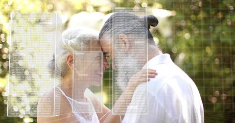 Mature couple touching foreheads in sunlit garden with futuristic binary data overlay