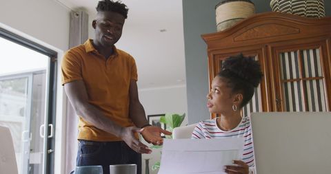 Couple Managing Finances with Laptop and Bills