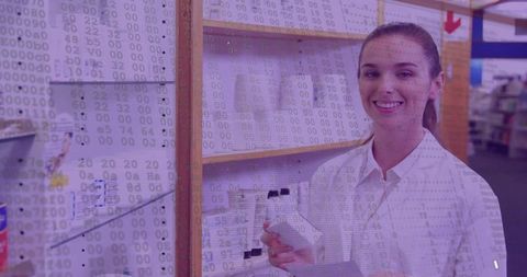 Smiling pharmacy assistant holding bottle and scanning barcode with digital code overlay