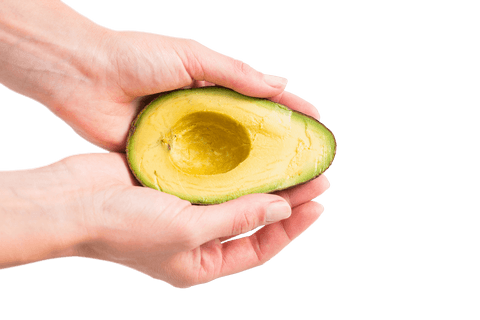 Hands holding ripe avocado half on transparent background