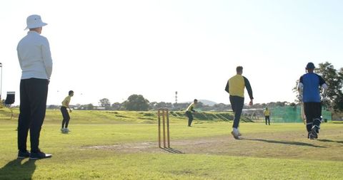 Youth cricket game in action on sunny day