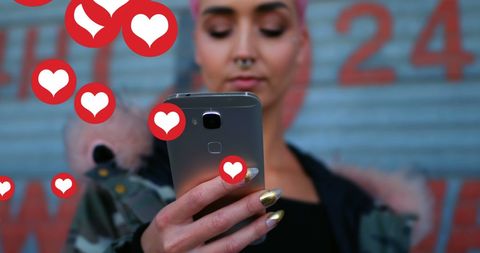 Woman Engaging with Social Media Icons on Smartphone