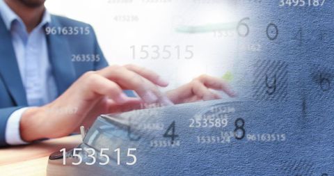Businessman typing amidst floating numbers background