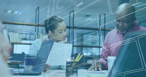 Professional Team Analyzing Documents in Modern Workspace