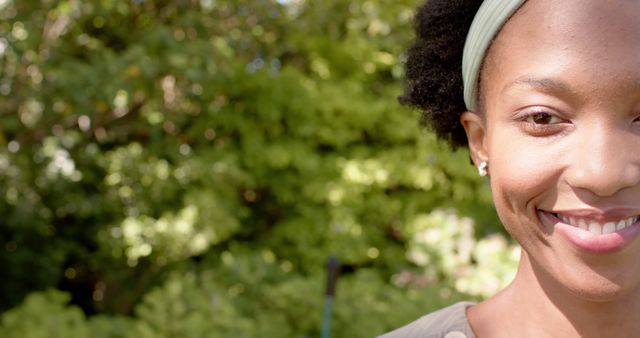 Close-Up of Smiling African American Woman with Headband Outdoors - Download Free Stock Images Pikwizard.com