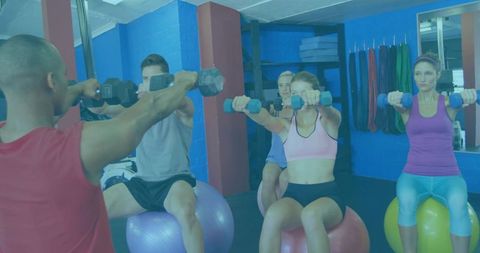 Diverse Group Performing Front Dumbbell Raises on Stability Balls