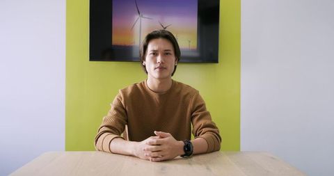 Young professional at conference table with modern technology