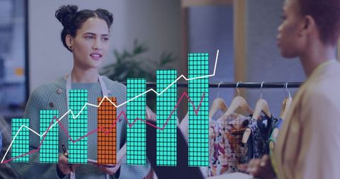 Businesswomen discussing sales analytics in fashion showroom